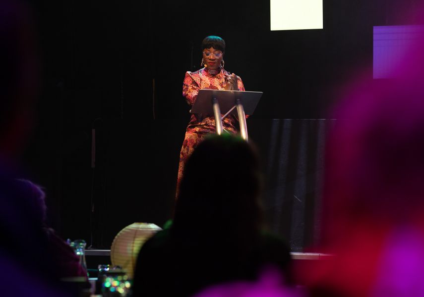 A woman stands on stage.