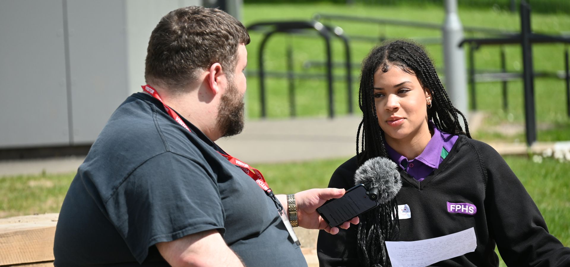 A FPHS pupil records soundscape content outdoors with a creative from Ergon Theatre Company